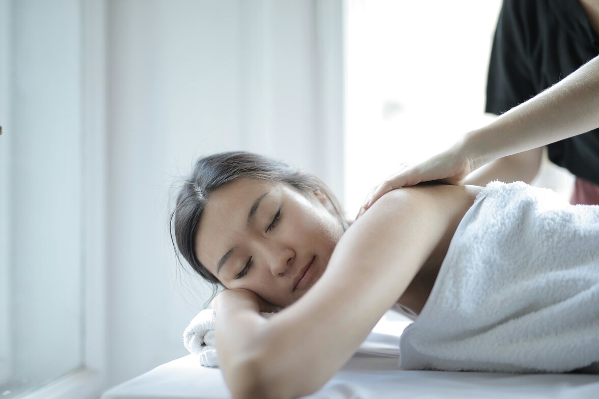 Woman getting massage laying down on stomach 